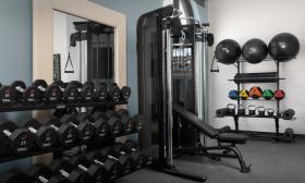 This newly renovated fitness room has weights and a weight bench 