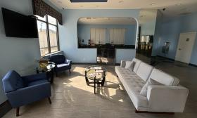 Plush sofa and chairs in blue and white create comfortable seating in this hotel lobby