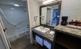 This hotel bathroom has a separate sink counter