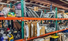 Warehouse shelves with parts for boats, including boat hatches