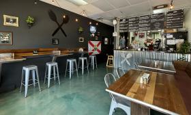 Bar stools and booths take up the indoor dining area