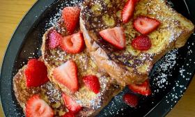 French toast with powdered sugar and strawberries on top