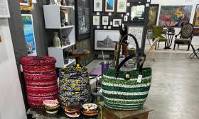 A displayof baskets, bags and paintings at a local gallery