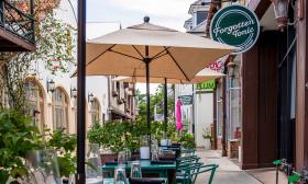 The eatery's exterior with tables lined up on the sidewalk