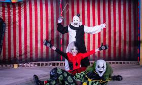 Three Halloween clowns posing before a performance