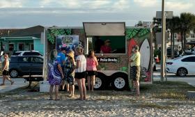 A food truck serves meals and drinks during the event