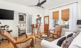 The living room in a vacation rental with wood floors, and beadboard ceilings