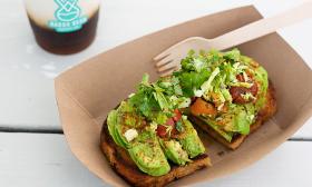 A tray of avocado toast with various toppings