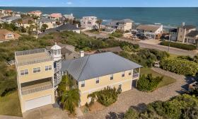 Called the "Lightkeepers" home, this multi-story yellow house is a block from the beach