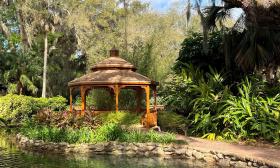 The gazebo, beside an old oak and a rock-lined pond, at Washington Oaks State Park