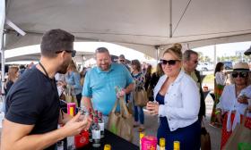 People attending a food and drink festival, get tastings of an adult beverage