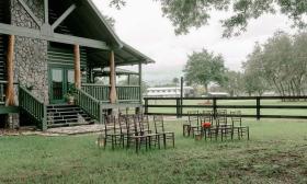 The modern farmhouse with chairs out in the yard