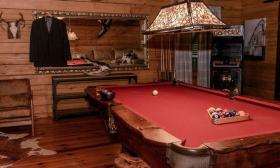 A pool table in the center of the grooms suite