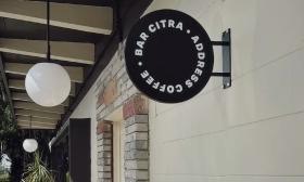 The shop sign outside of Citra's building