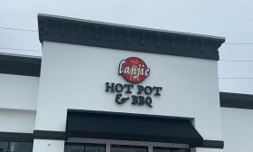 The outdoor sign for Lanjie Hot Pot & BBQ