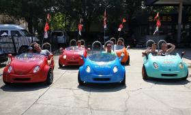 Guests riding in the multi-colored scoot coupes