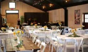 Tables with sunflower centerpieces set up