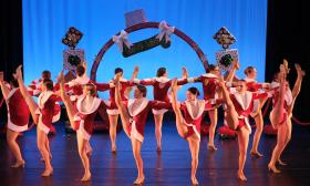 Dancers doing high kicks in a circle