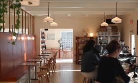 The inside of the cafe with seating along the walls