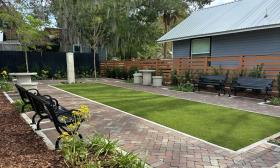 A grassy area with benches surrounding the space