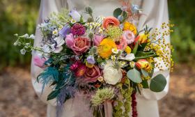 A colorful bouquet held by a bride