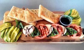 An avocado and caprese board served at brunch