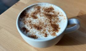 A chai latte topped with spices in a mug