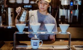 An employee preparing fresh coffee