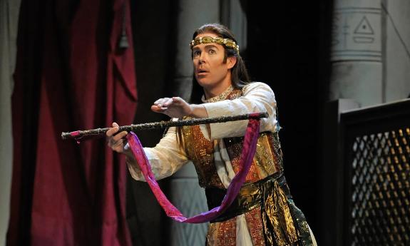 An actor in First Coast Opera's production of Magic Flute extends the flute in question