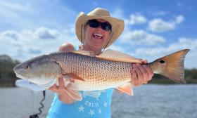 A woman with a freshly caught fish