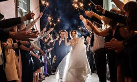 Guests sending off the newlyweds with sparklers