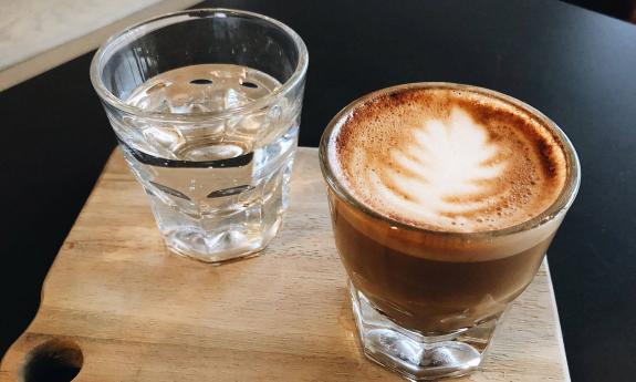 A hot latte and a glass of water