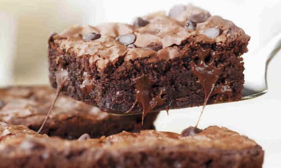 A piece of a chocolate chip brownie