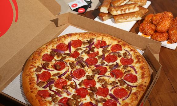 A box of pizza with various toppings