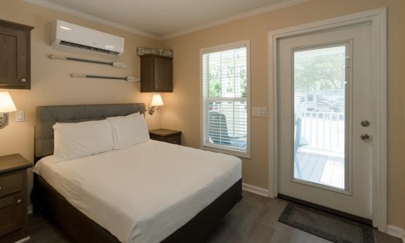 The bedroom in a park row vacation rental has a small deck 