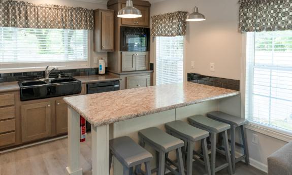 The kitchen in this park row vacation rental has a dishwasher, microwave, stove, stove and refrigerator with an eat-on island