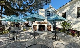 Outdoor patio seating with a fireplace in the center