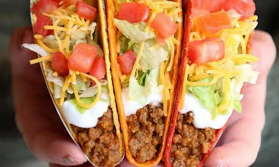 Doritos locos tacos being held up