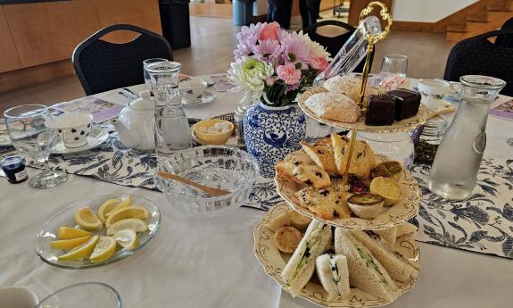 Sweets and tiny sandwiches arranged on the table