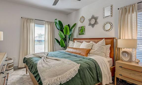 This bedroom at Flagler Crossing has large windows and room for night stands, dressers, and chests of drawers