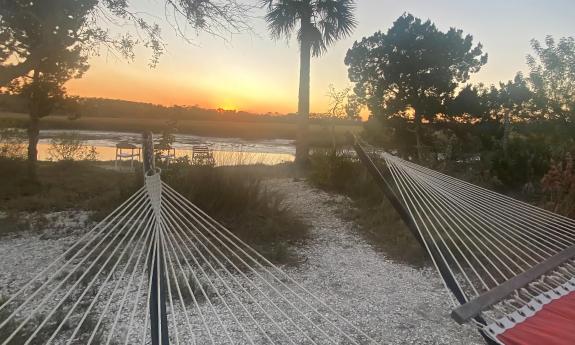 The foot of two hammocks point to the San Sebastian River at sunset