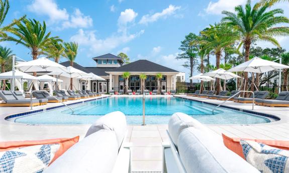 The resort-style pool at Flagler Crossing in St. Augustine has sun umbrellas, lounge chairs and a cabana