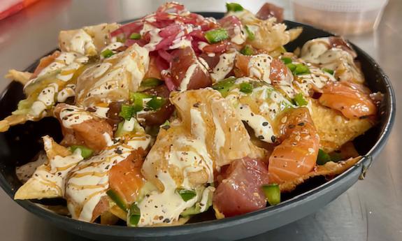 A poké bowl with an assortment of goodies and sauce