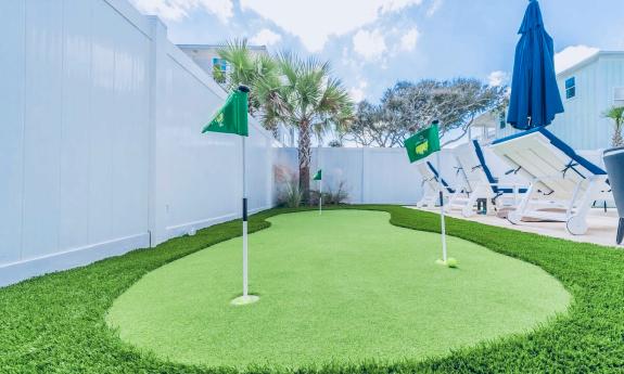 A putting green, near the pool of a vacation rental near St. Augustine Beach