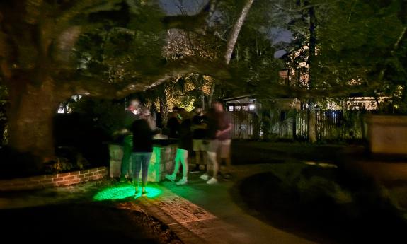 Tour guides and guest seek spirits with the aid of a green light