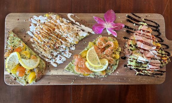 Various avocado toasts served with dressings and garnishes