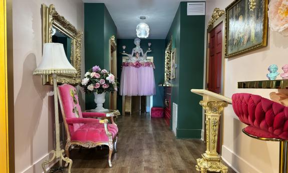 A hallway with elegant decor leading to the ordering counter