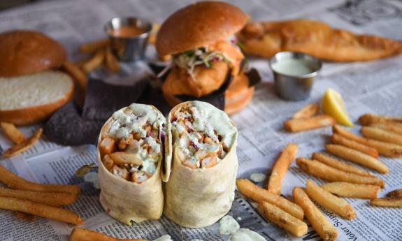 Seafood meals spread out on a table covered with paper that looks like newprint