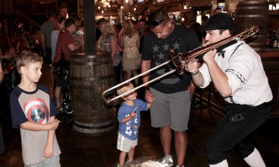 Jason Sieboda from Those Guys (of Orlando) shows two young fans the joy of playing music.