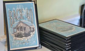 A stack of Back 40 menus that offers a variety of food and drink selections